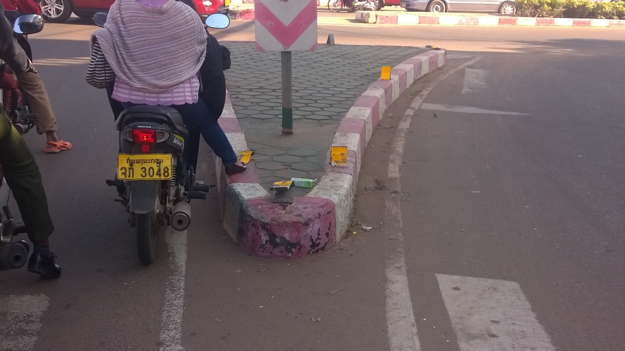 Wie man auf fast 30 cm hohen Verkehrsinseln die Reflektorfaehnchen abfahren kann bleibt ds Geheimnis der Laoten...